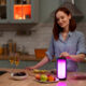 Image: A person joyfully preparing a meal with the Samsung Food App on their tablet, surrounded by fresh ingredients and kitchen utensils.