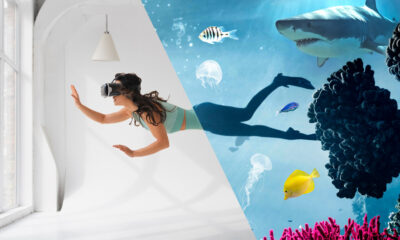 Scuba diver observing sharks in an underwater tunnel.