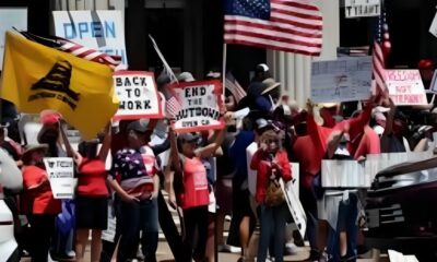 Diverse crowd of protesters in San Diego demanding justice.