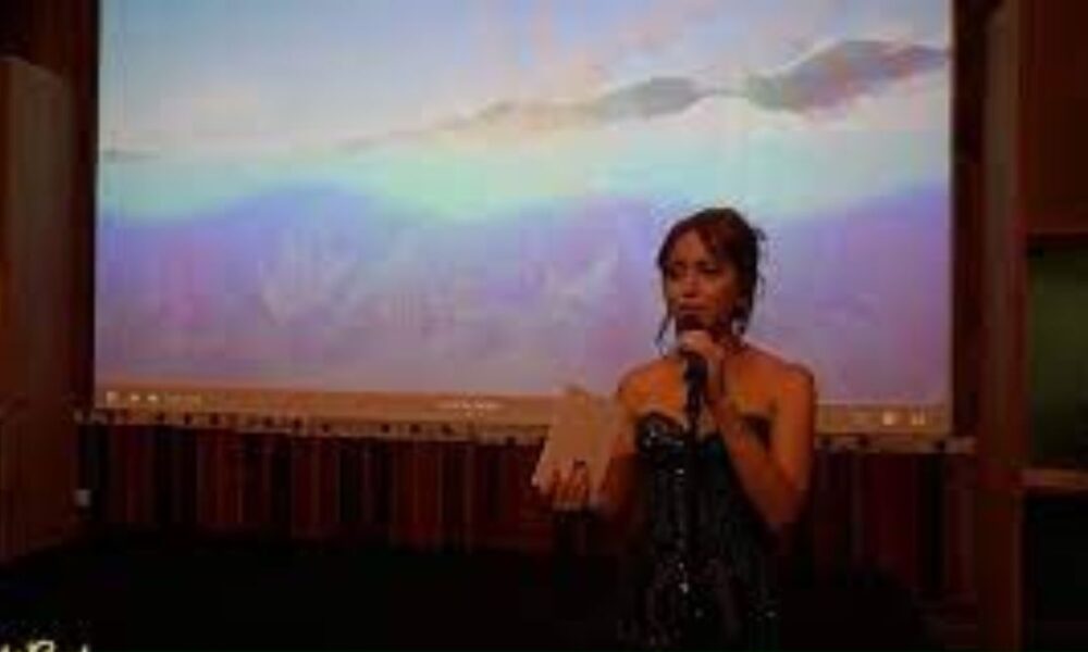 Maya's Presentation-on-stage-with-audience