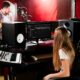 Students collaborating in a music production studio, representing the creative atmosphere of Los Angeles music schools.