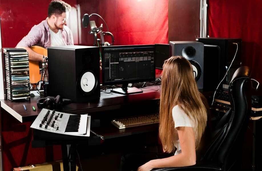 Students collaborating in a music production studio, representing the creative atmosphere of Los Angeles music schools.